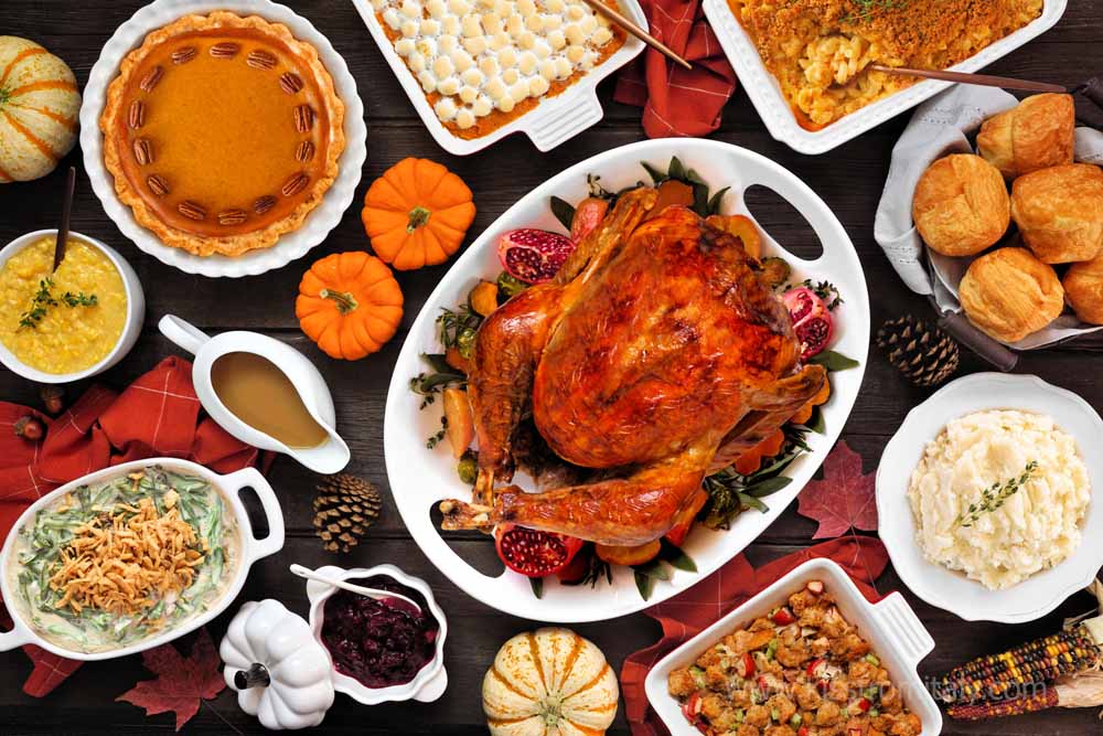 table with turkey, pecan pie, and other traditional foods for Thanksgiving in Florence